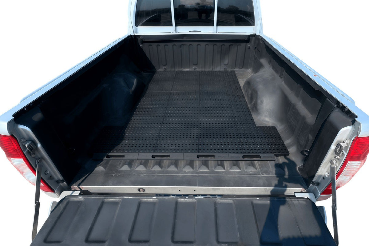 White pickup truck bed with TONGJING modular cargo organizer grid installed